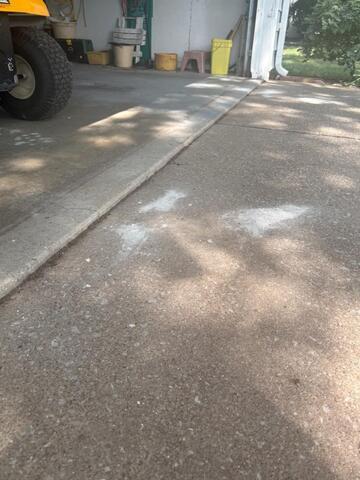 Repairing a cracked driveway in North Ridgeville, OH.