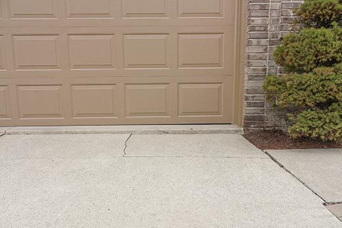 Repairing a cracked driveway in North Ridgeville, OH.