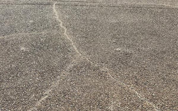 Repairing a cracked driveway in North Ridgeville, OH.