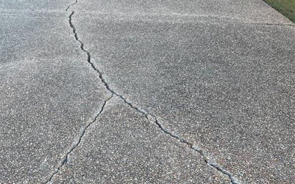 Repairing a cracked driveway in North Ridgeville, OH.