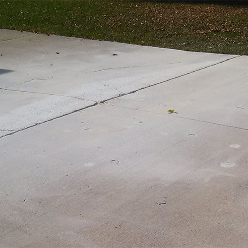Repairing a cracked driveway in North Ridgeville, OH.